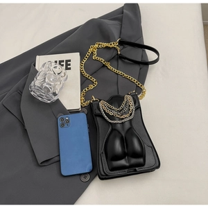 Detail of unique female body silhouette cross-body bag with stylish gold chain strap
