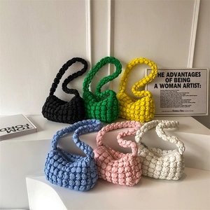 Bubble textured popcorn crossbody bags in six vibrant colors on a minimalist display