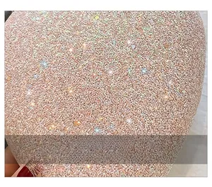 Macro detail of high-quality pink gold sequin fabric with sparkling texture for crossbody bag