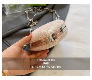 Macro bottom view of heart-shaped evening bag with pink gold sequins and metal frame