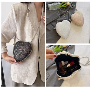 Sparkling heart-shaped clutch bag interior showing space for makeup and lipstick