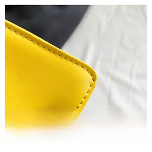 Close-up of yellow leather crossbody bag showing precise stitching and fine texture