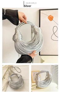 Detailed close-up of metallic silver woven crescent bag with tubular rope knots