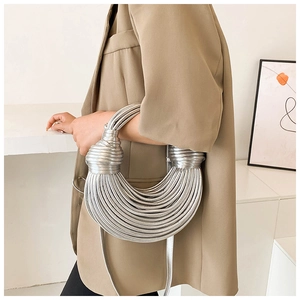 Close-up of silver crescent bag with unique spiral texture and liquid metal finish
