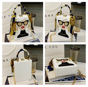 Detail of box bag with pop art portrait illustration and decorative scarf handle