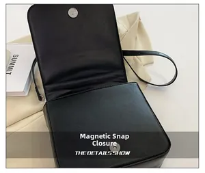 Detail view of the black retro small square bag showing the magnetic snap closure system
