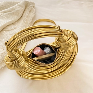 Metallic gold hand-woven knot handbag with a 45-degree angle showing the interior capacity