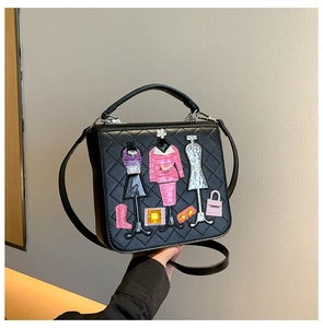 Detail of black PU leather crossbody bag with rhombic stitching and 3D applique embroidery