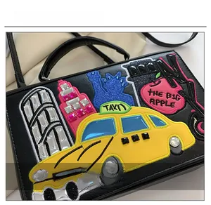 Detail of New York city embroidery with rhinestones on a vintage black handbag