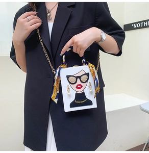 Detail of white box bag with fashion illustration, chain strap and silk scarf handle