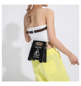 Detail of creative caution sign handbag with silver bead chain and white printed letters