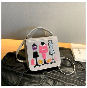 Detail of light gray crossbody bag featuring fashion model applique embroidery and sequins