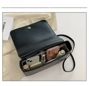 Interior view showing the capacity of a black vintage embroidered crossbody handbag