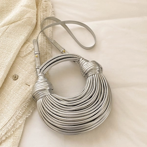 Silver woven knot handbag with metallic texture and sleek crossbody shoulder strap
