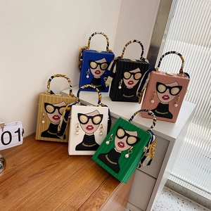 Detail of colorful box bags with portrait prints, silk scarf handles, and pearl charms
