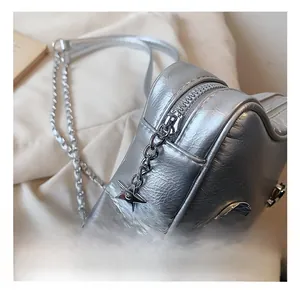 Detailed macro view of silver metallic bag with star-shaped zipper and moon decoration