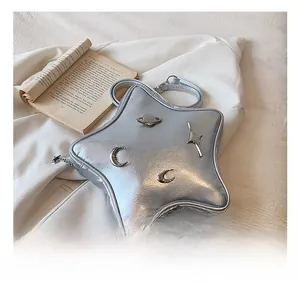 Detail of silver star-shaped bag with metallic texture and celestial charms