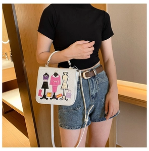 Detail of colorful knitted fashion embroidery on a white rectangular top-handle handbag