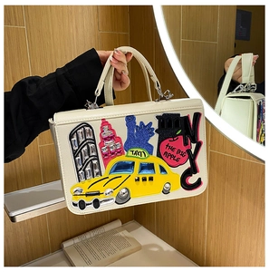 Detail of vintage Baroque handbag with 3D NYC embroidery and yellow taxi patch