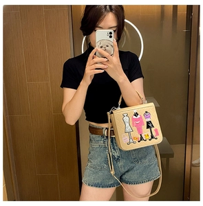 Mirror selfie showing a beige quilted crossbody bag with stylish mannequin embroidery details