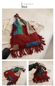 Detail of red patchwork knitted tote bag with colorful blocks and bohemian fringe tassels