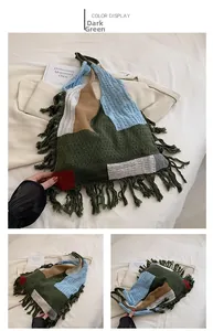 Detail view of dark green knitted patchwork tote bag with stylish fringe and tassel accents