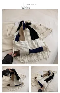 Macro detail of the color block knitted tote bag featuring long fringes and soft cotton texture
