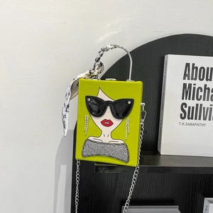 Detail of lime green box bag featuring art illustration and silk-wrapped metal handle