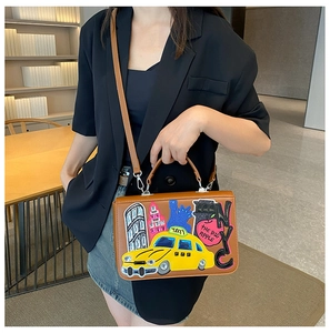 Detail of vintage Baroque handbag featuring colorful NYC NYC embroidery and taxi patches