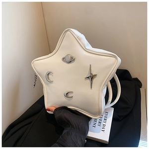 Detailed macro view of the star-shaped crossbody bag with silver celestial metal charms