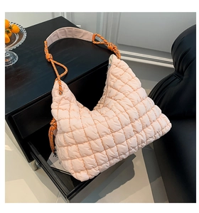 Détail du sac matelassé avec poignée en corde tressée et fermeture éclair argentée