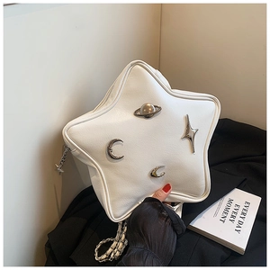 Detail of star-shaped white leather bag featuring silver celestial metal decorations