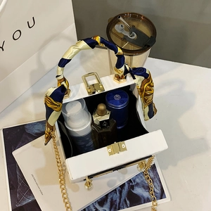 Elegant white box clutch with silk scarf handle, pearl gold chain, and makeup storage space