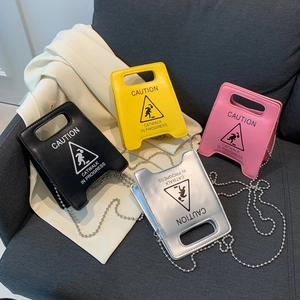 Fashion caution sign crossbody bags in black, yellow, pink, and silver with chain straps