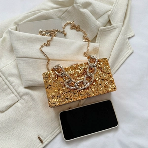 Golden acrylic hard shell box bag with hammered texture and metal chain straps