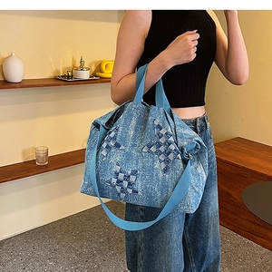 Blue denim tote bag detail featuring 3D star patchwork and adjustable shoulder strap