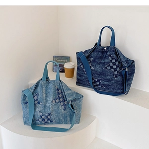 Detail of star-shaped checkerboard patches on large denim tote bags in blue