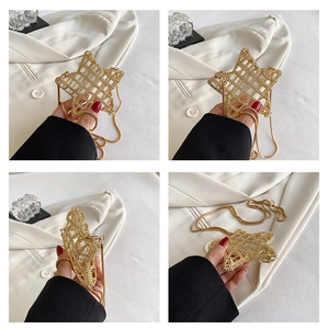 Detail of star-shaped golden hollow mesh mini bag with metallic crossbody chain strap