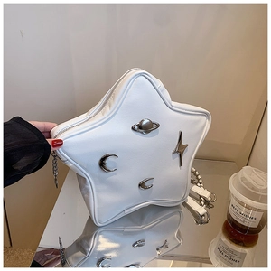 Detail of white star-shaped leather bag with silver cosmic hardware and chain strap