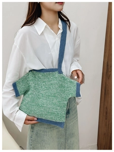 Detail of creative T-shirt shaped knit shoulder bag featuring green and white texture