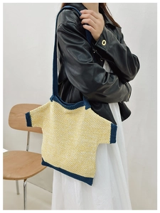Detail of knit tote bag designed as a t-shirt with navy trim and shoulder strap