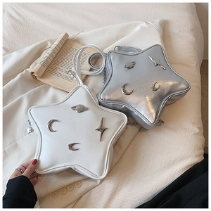 Detail showing star-shaped bags in white and silver with metallic moon and planet accents