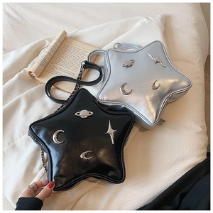 Detail view of star-shaped crossbody bags in black and silver with metallic accents