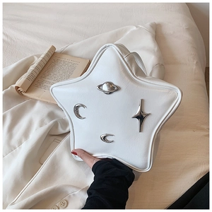 Detailed view of a star-shaped white leather bag with silver cosmic metal ornaments