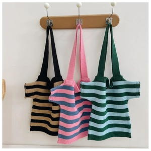 Detailed close-up of thick knitted tote bags in creative t-shirt shapes and striped patterns