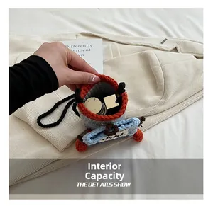 Detail view of the interior capacity of a handmade crochet mini crossbody bag with cosmetics
