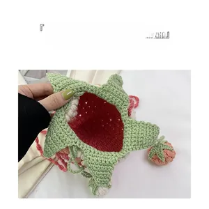 Close-up showing interior capacity of handmade strawberry crochet crossbody bag