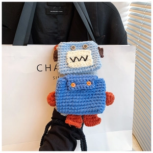 Detailed close-up of a handmade crochet robot mobile phone bag with button eyes