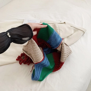 Boho style patchwork knit shoulder bag with colorful fringe and chunky texture detail