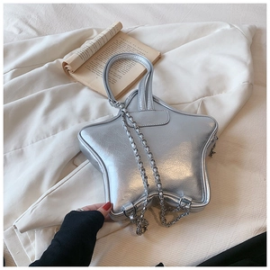 Detailed view of silver star-shaped bag with wrinkled PU leather and chain strap